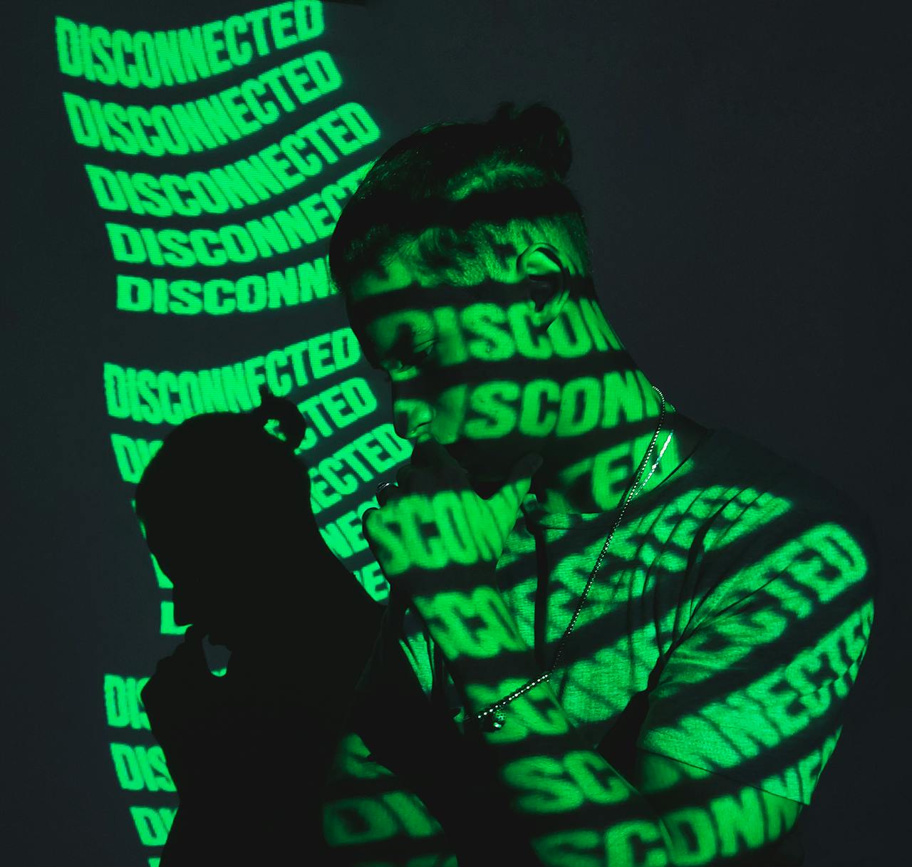 Man Standing in the Light of a Projector